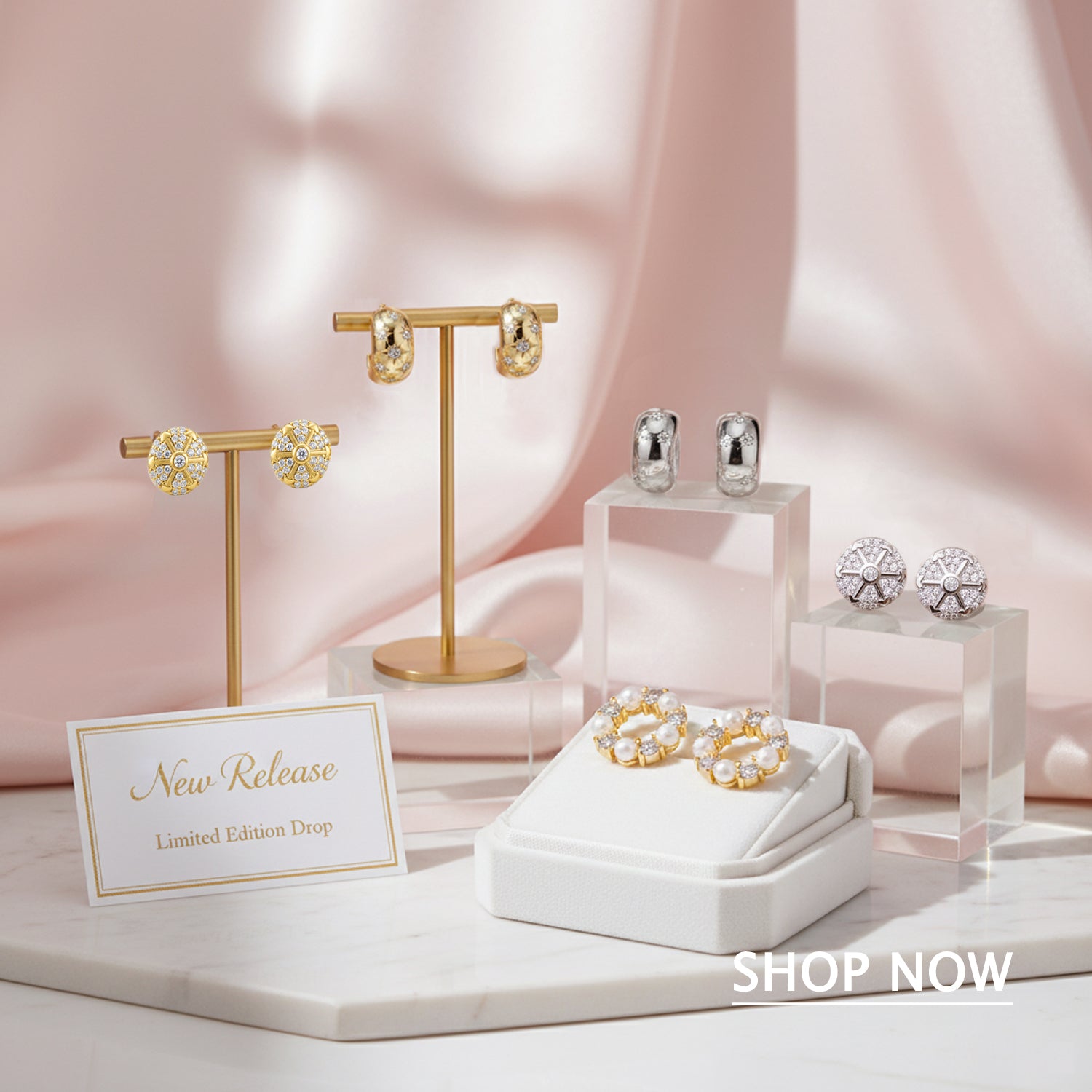 Jewelry display with earrings on a pink fabric background